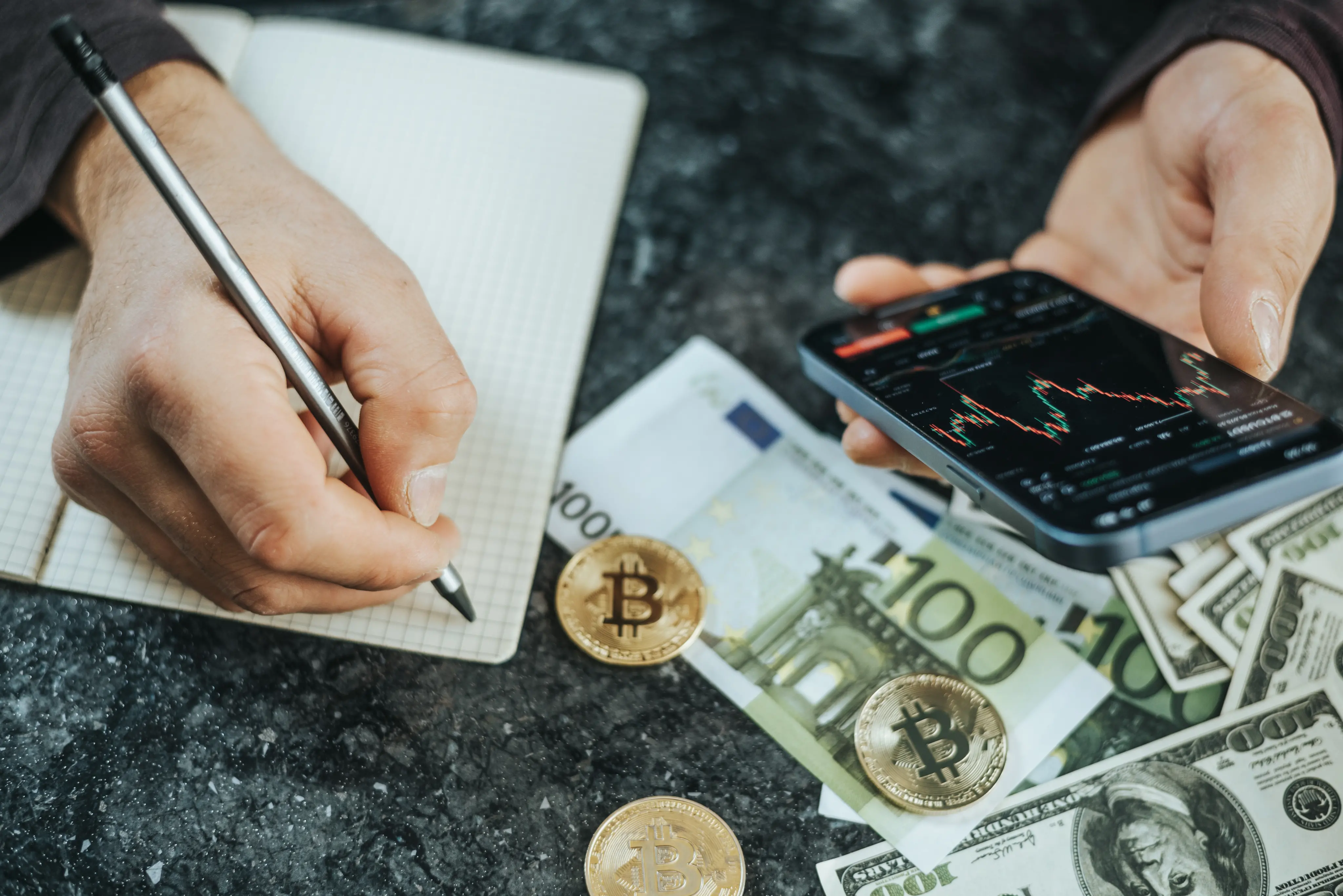 Investor reviewing crypto market data with euros notes and Bitcoin coins